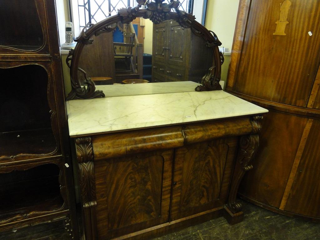 Appraisal: A Victorian mahogany chiffonier the raised mirror back of arched