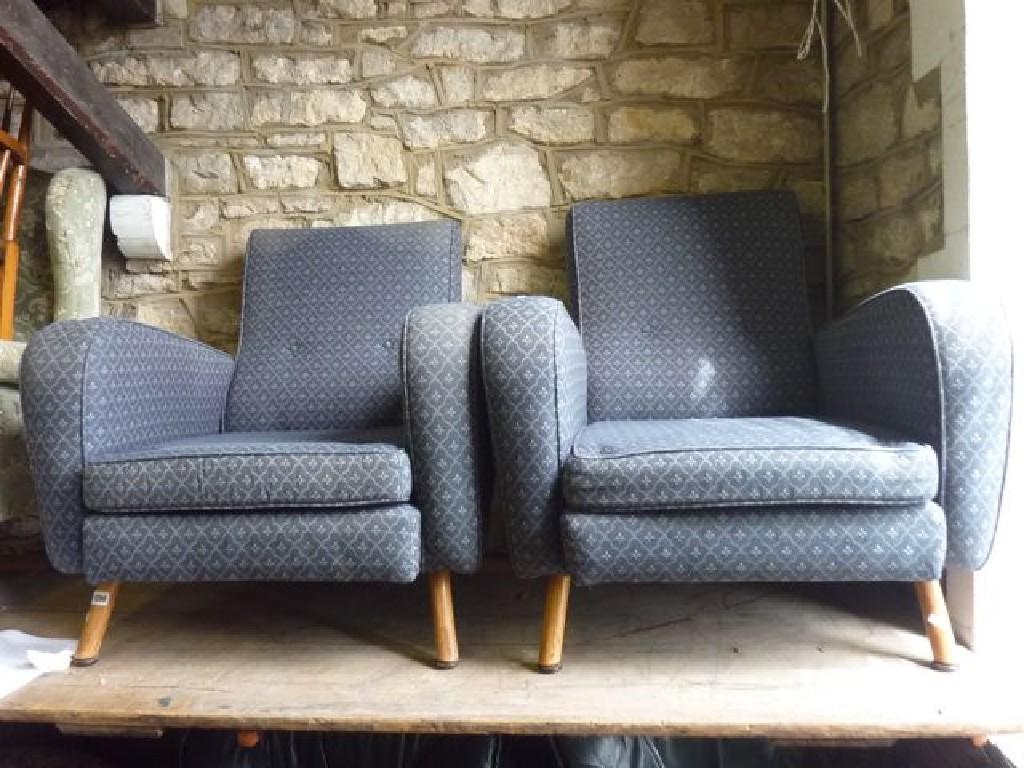 Appraisal: A pair of retro armchairs with shaped outline upholstered finish