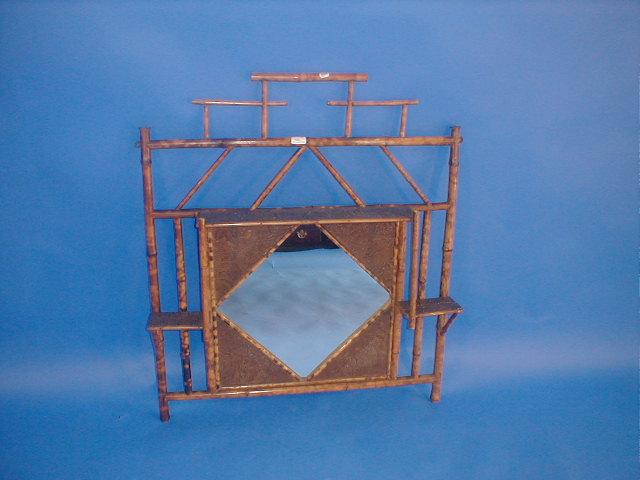 Appraisal: A Victorian bamboo over mantel mirror with embossed staging and