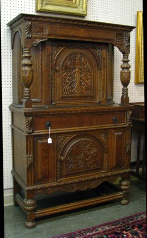 Appraisal: Circa 's carved oak wine cabinet one-piece construction on leg