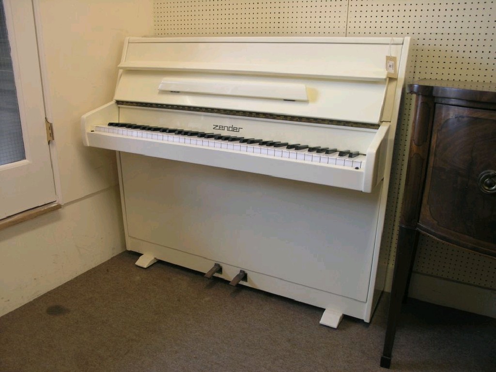 Appraisal: A Zender small size upright piano six octave keyboard cream