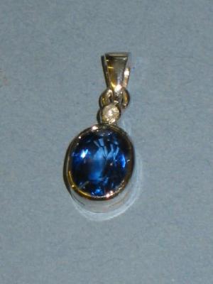 Appraisal: A SAPPHIRE PENDANT the oval sapphire collet set in white