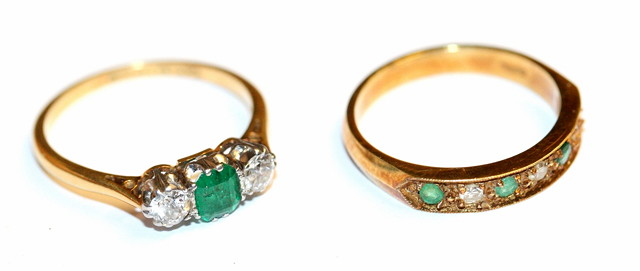 Appraisal: A THREE STONE EMERALD AND DIAMOND RING set with claws