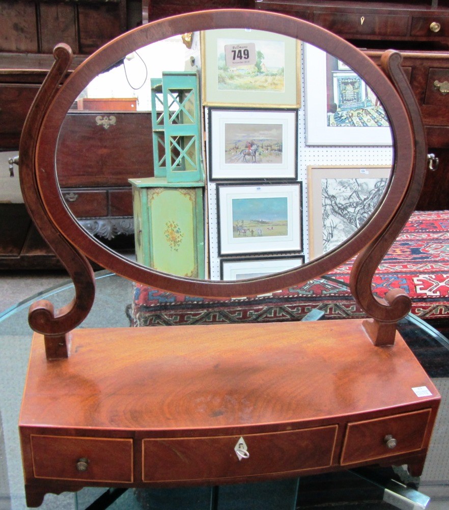 Appraisal: An early th century mahogany toilet mirror with bowfront three