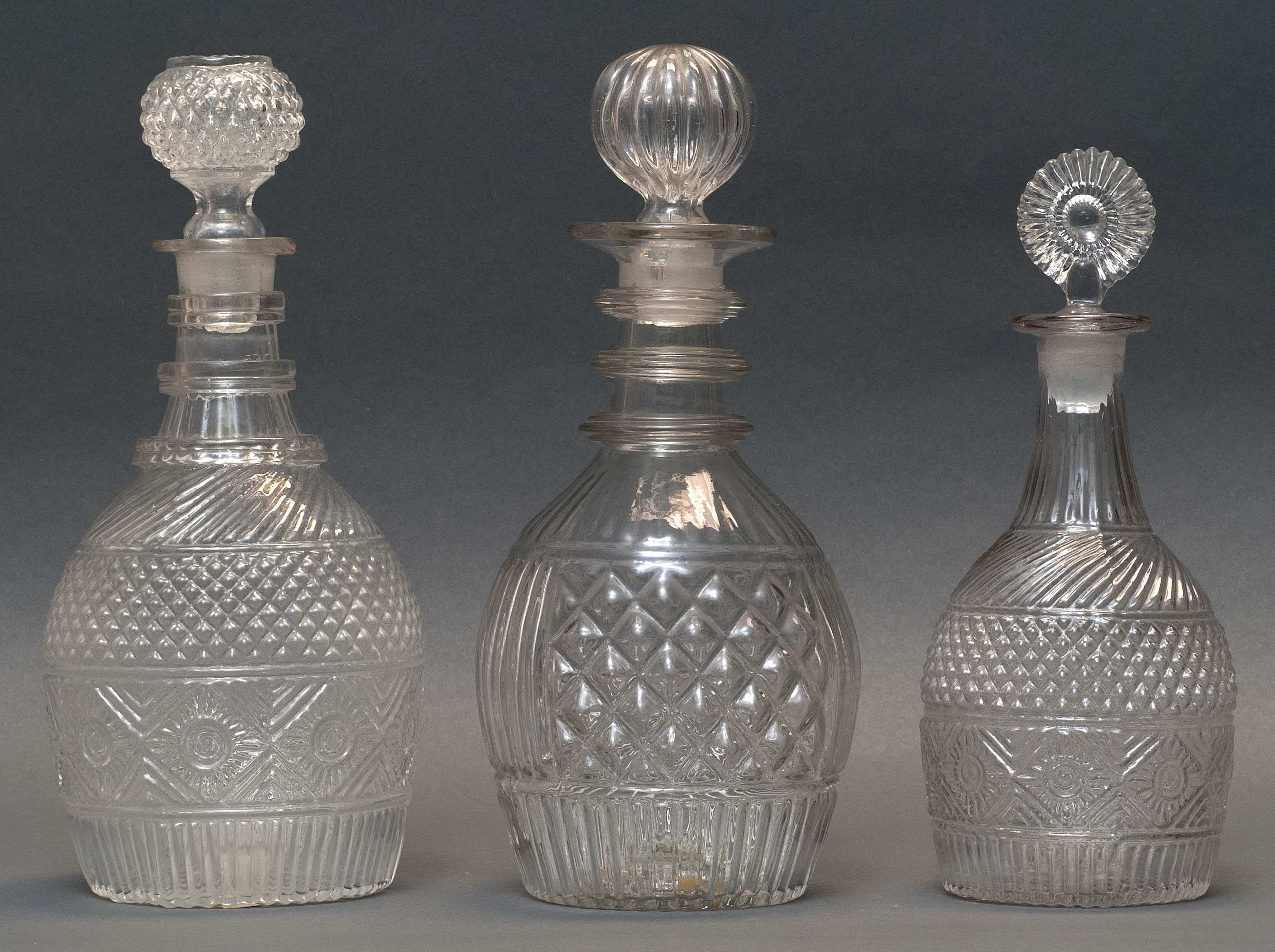 Appraisal: THREE CLEAR GLASS BLOWN -MOLD DECANTERS Second Quarter of the