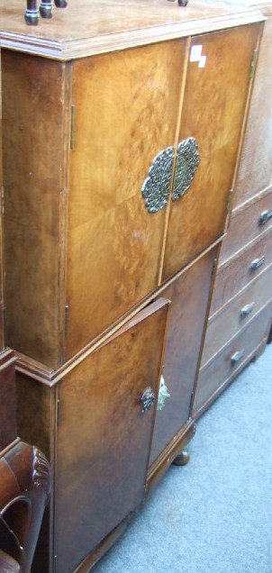 Appraisal: A burr walnut side cabinet with a pair of cupboard