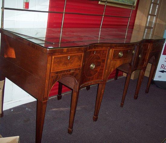 Appraisal: A George III style mahogany serpentine sideboard with brass rails