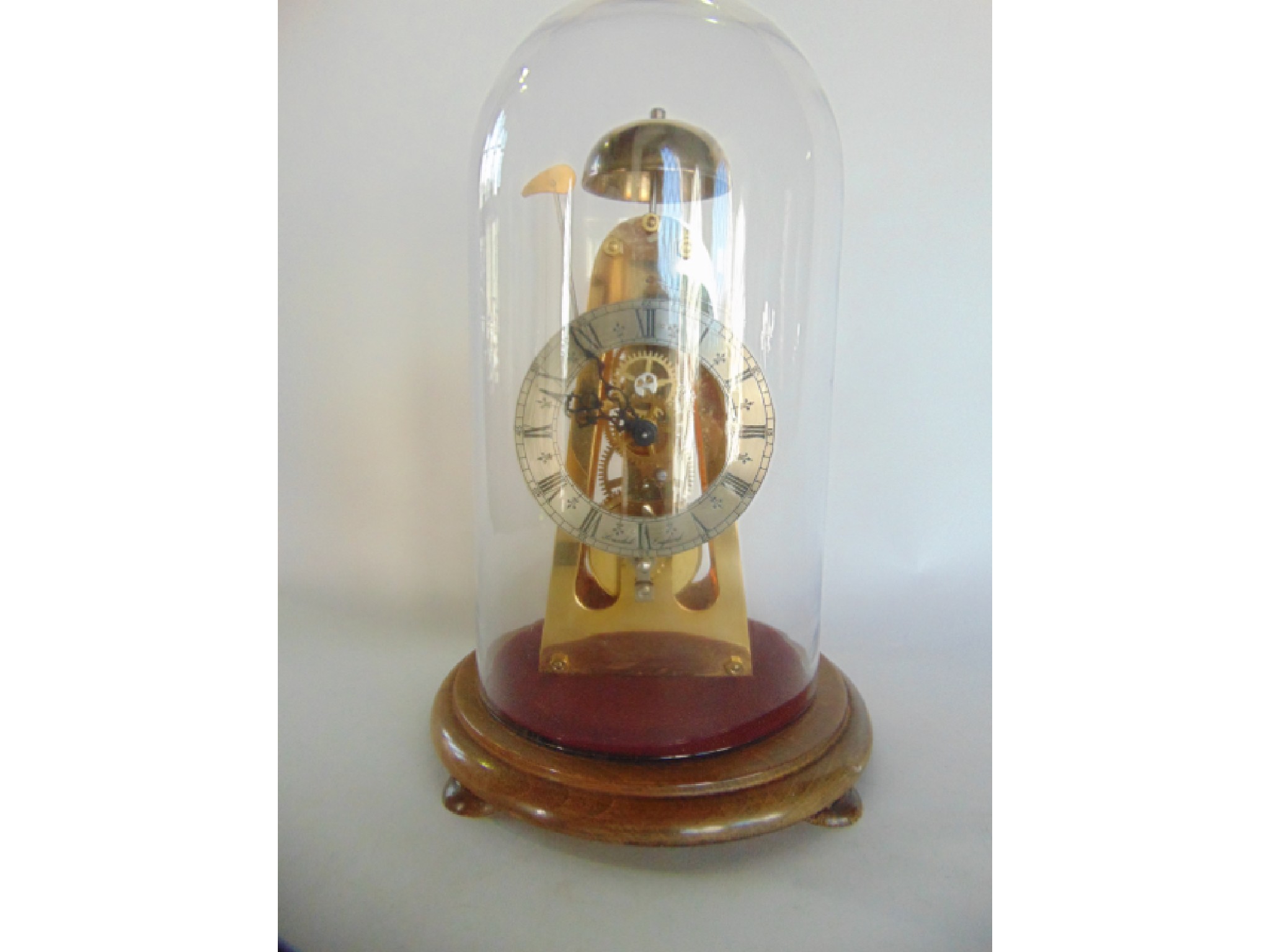 Appraisal: A simple skeleton clock in brass striking on a bell