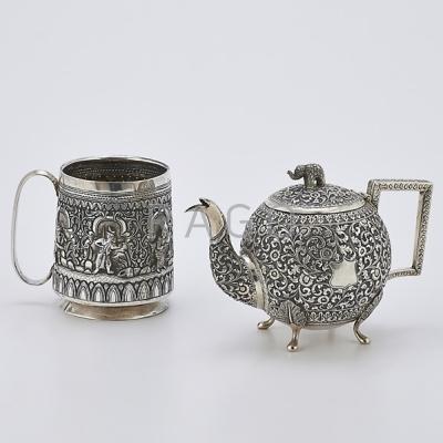 Appraisal: TWO INDO-PERSIAN SILVER VESSELS Spherical teapot with foliate chasings pad