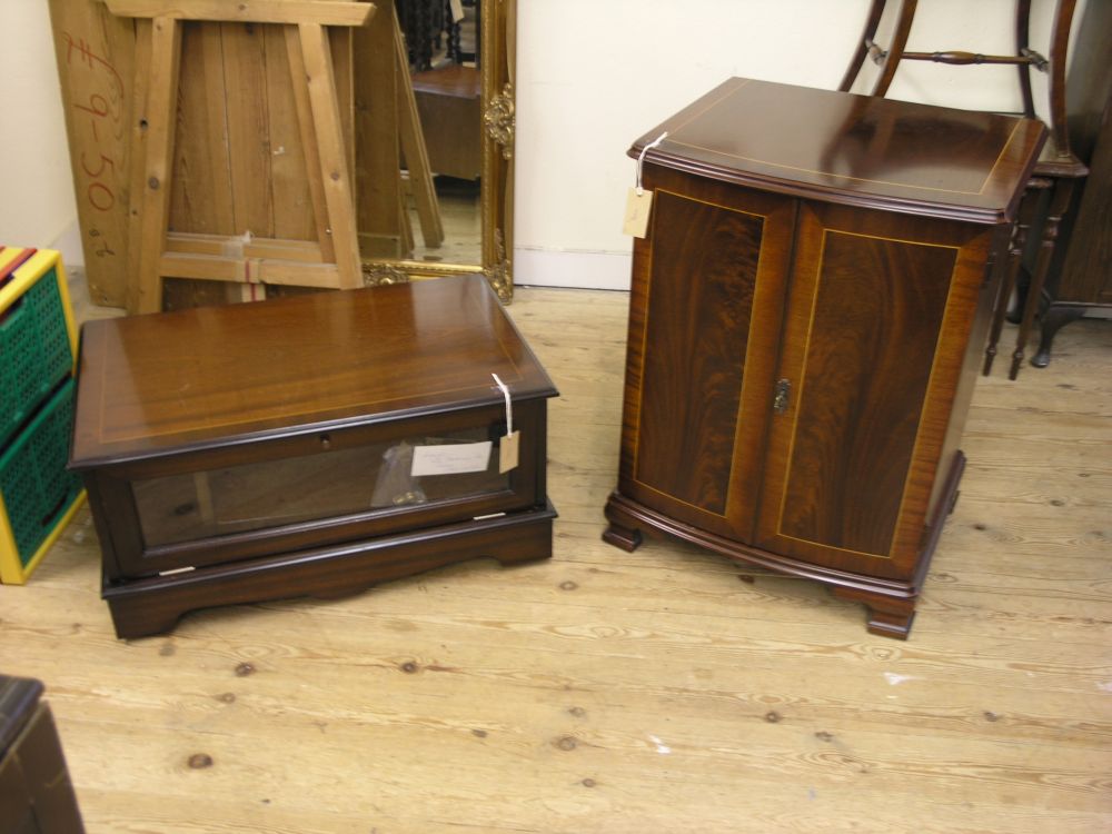 Appraisal: A reproduction mahogany bow front cupboard enclosed by a pair