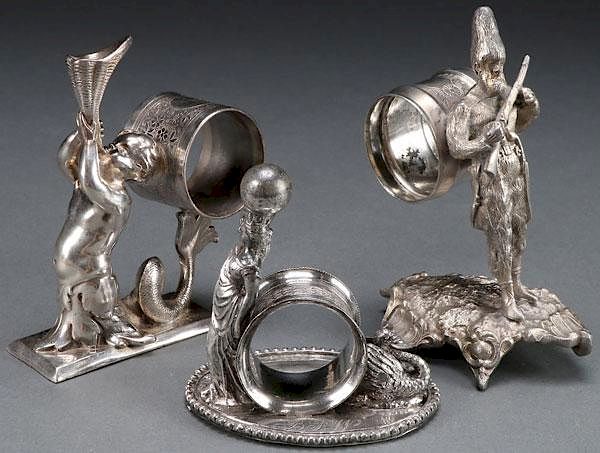 Appraisal: VICTORIAN SILVERPLATE FIGURAL NAPKIN RINGS THREE VICTORIAN SILVER PLATE FIGURAL