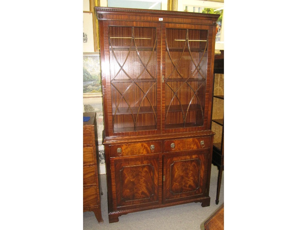 Appraisal: Good quality reproduction mahogany bookcase on cabinet