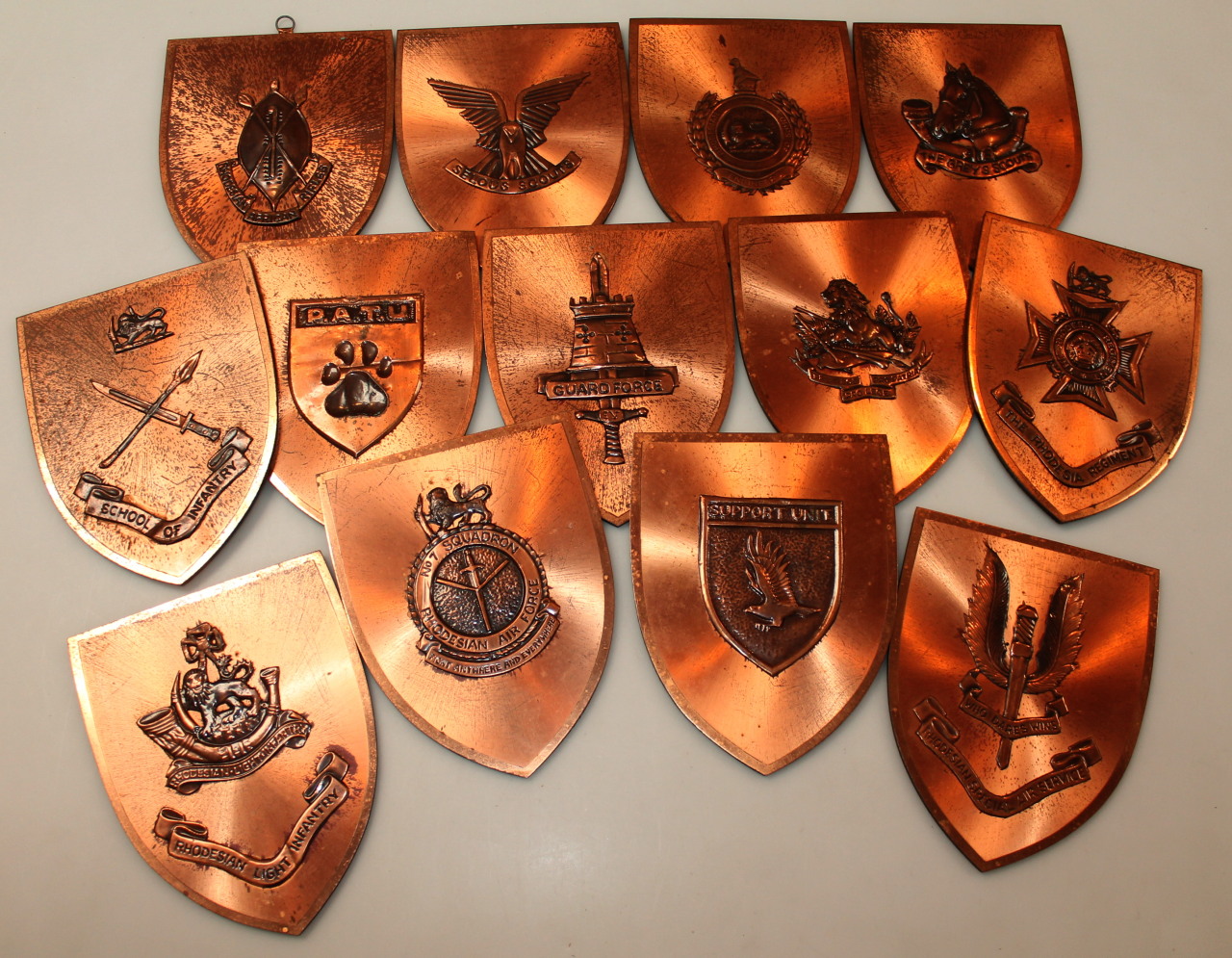 Appraisal: Various thC African copper shields to include Rhodesian Light Infantry