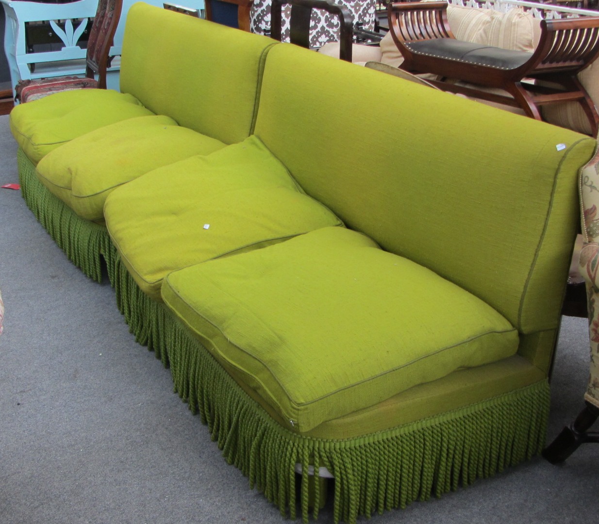 Appraisal: A pair of th century green upholstered two seat sofas