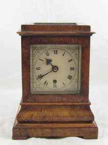 Appraisal: An eight day walnut cased mantel clock with bevelled glass