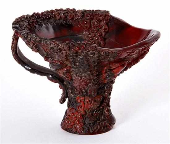 Appraisal: Chinese carved rhinoceros horn libation cup th century dark amber-brown