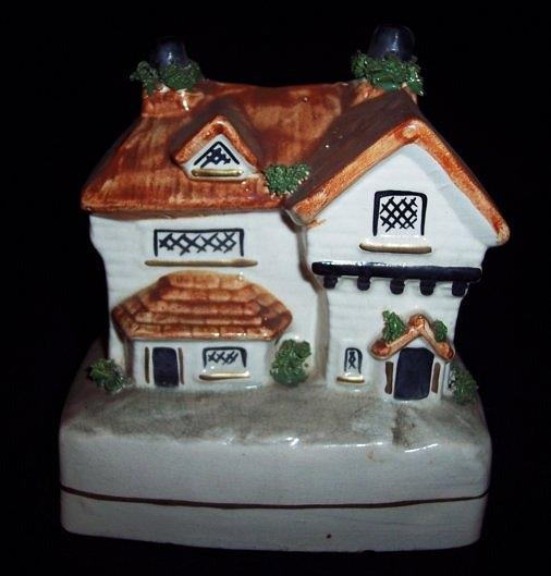 Appraisal: A Staffordshire three-storey cottage money box with dormer window cm