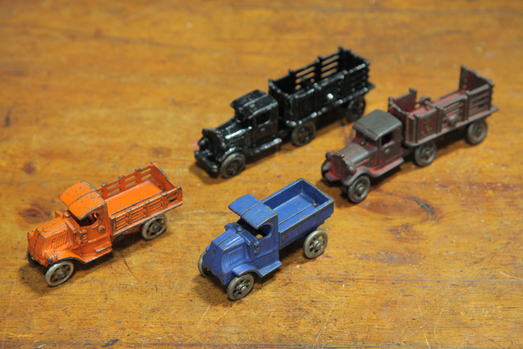 Appraisal: FOUR CAST IRON TRUCKS American early th century Two Coast