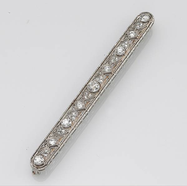 Appraisal: An art deco diamond platinum and k gold bar brooch