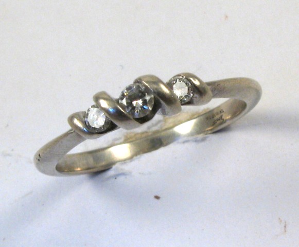 Appraisal: DIAMOND AND TEN KARAT WHITE GOLD RING set with three