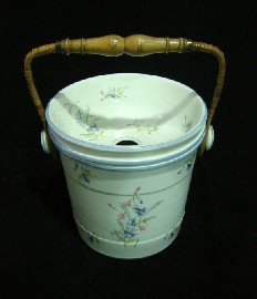 Appraisal: A large French porcelain pail with inset drainer and wicker