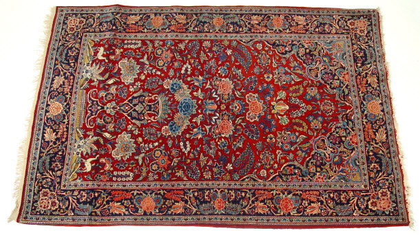 Appraisal: Rectangular red and blue ground rug profusely decorated with a