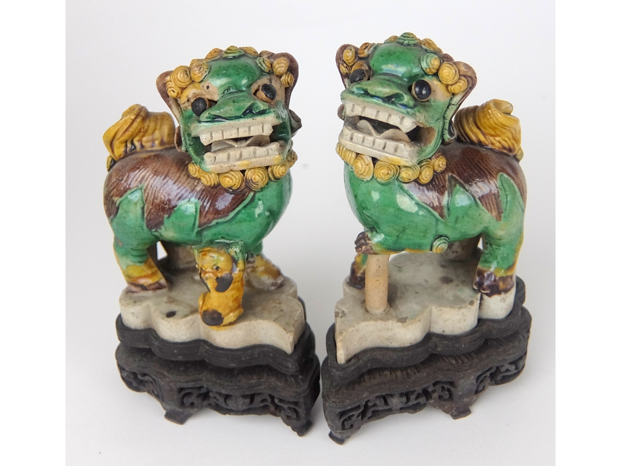 Appraisal: A pair of Chinese famille verte shishi joss stick holdersstanding