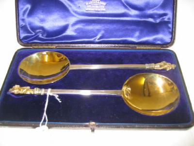 Appraisal: A PAIR OF VICTORIAN GILDED SERVING SPOONS with apostle finials