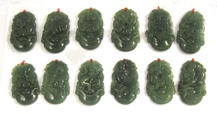 Appraisal: TWELVE CARVED JADE ZODIAC PENDANTS each dark green pendant measuring