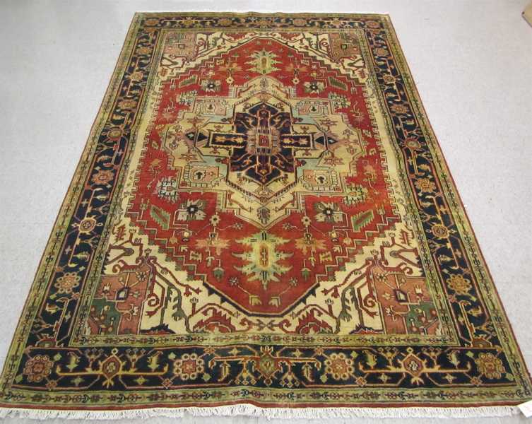 Appraisal: HAND KNOTTED ORIENTAL CARPET Persian Serapi design central geometric medallion