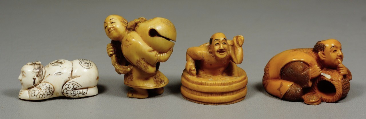 Appraisal: carved ivory Japanese netsuke men holding objects man kneeling one