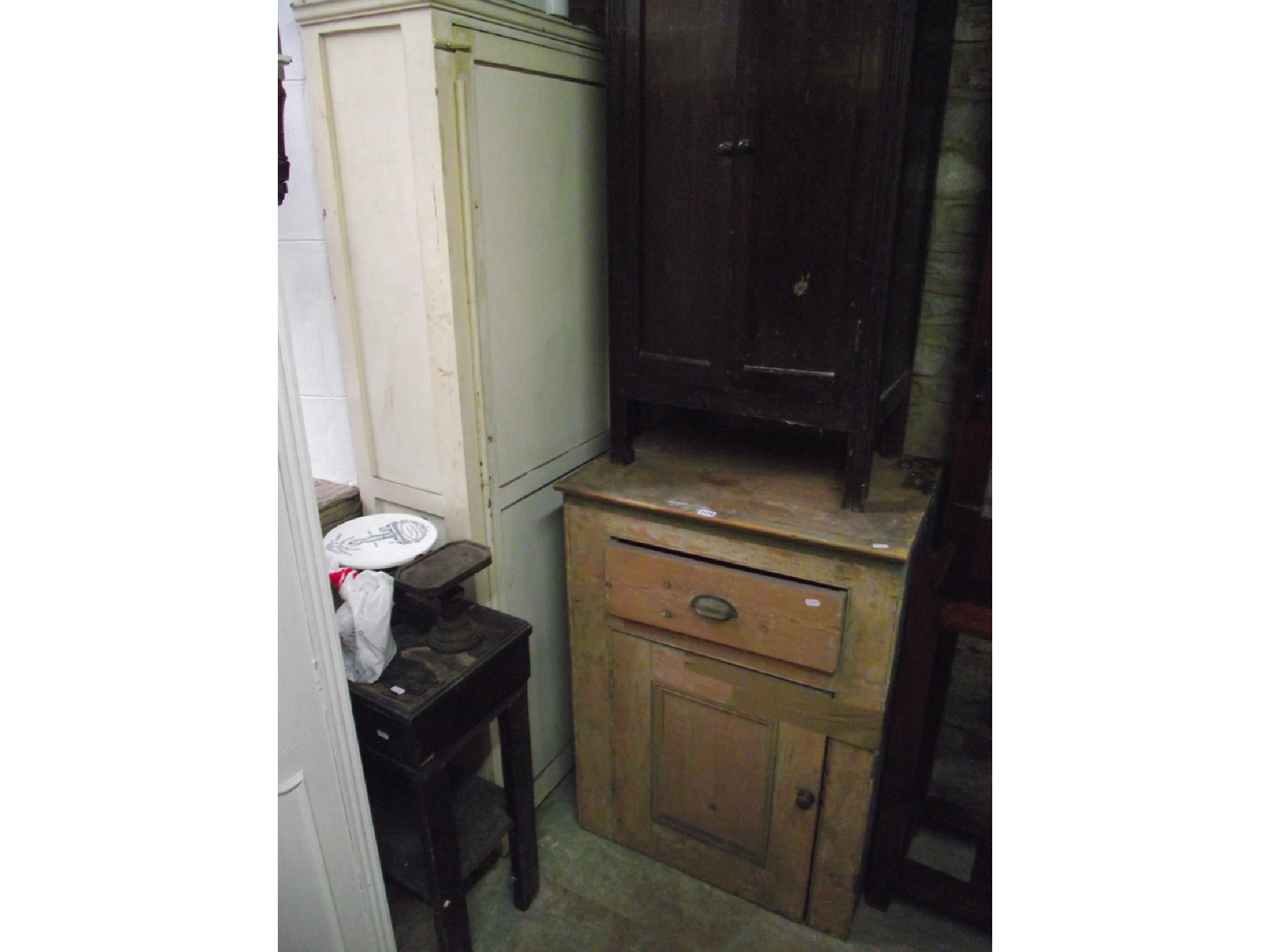 Appraisal: A partially stripped old pine pedestal kitchen cupboard partially enclosed