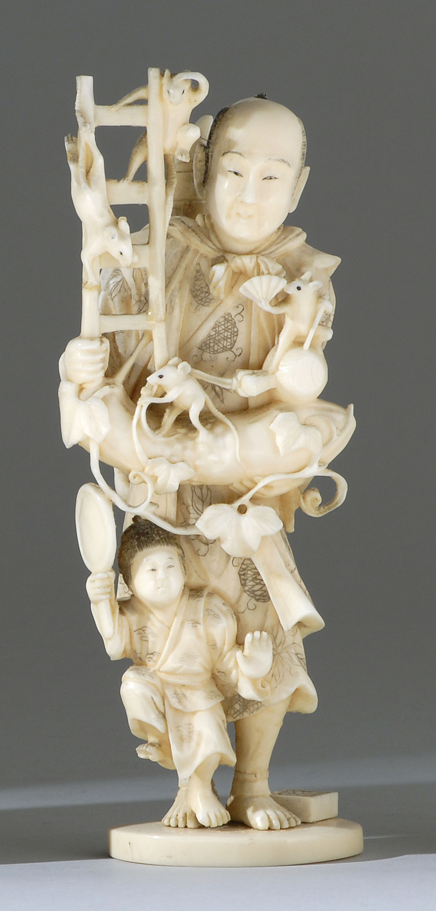 Appraisal: IVORY FIGURE GROUP Meiji PeriodDepicting a man and child harvesting