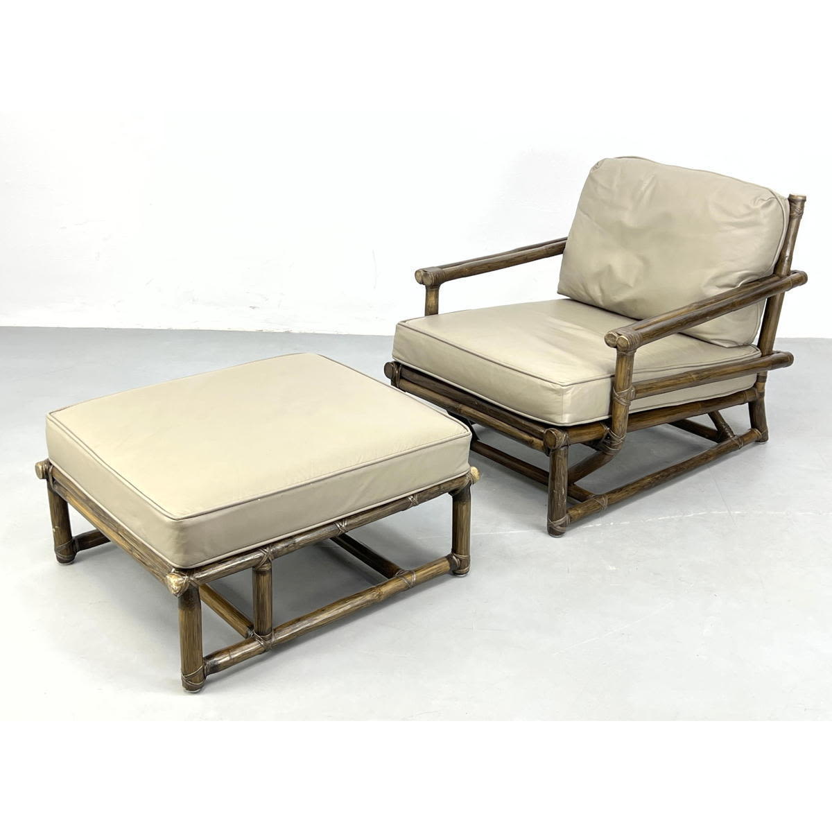 Appraisal: McGuire Dark Rattan Lounge Chair and Ottoman Wrapped rattan frames