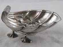 Appraisal: A silver deeply formed shell dish on three feet by