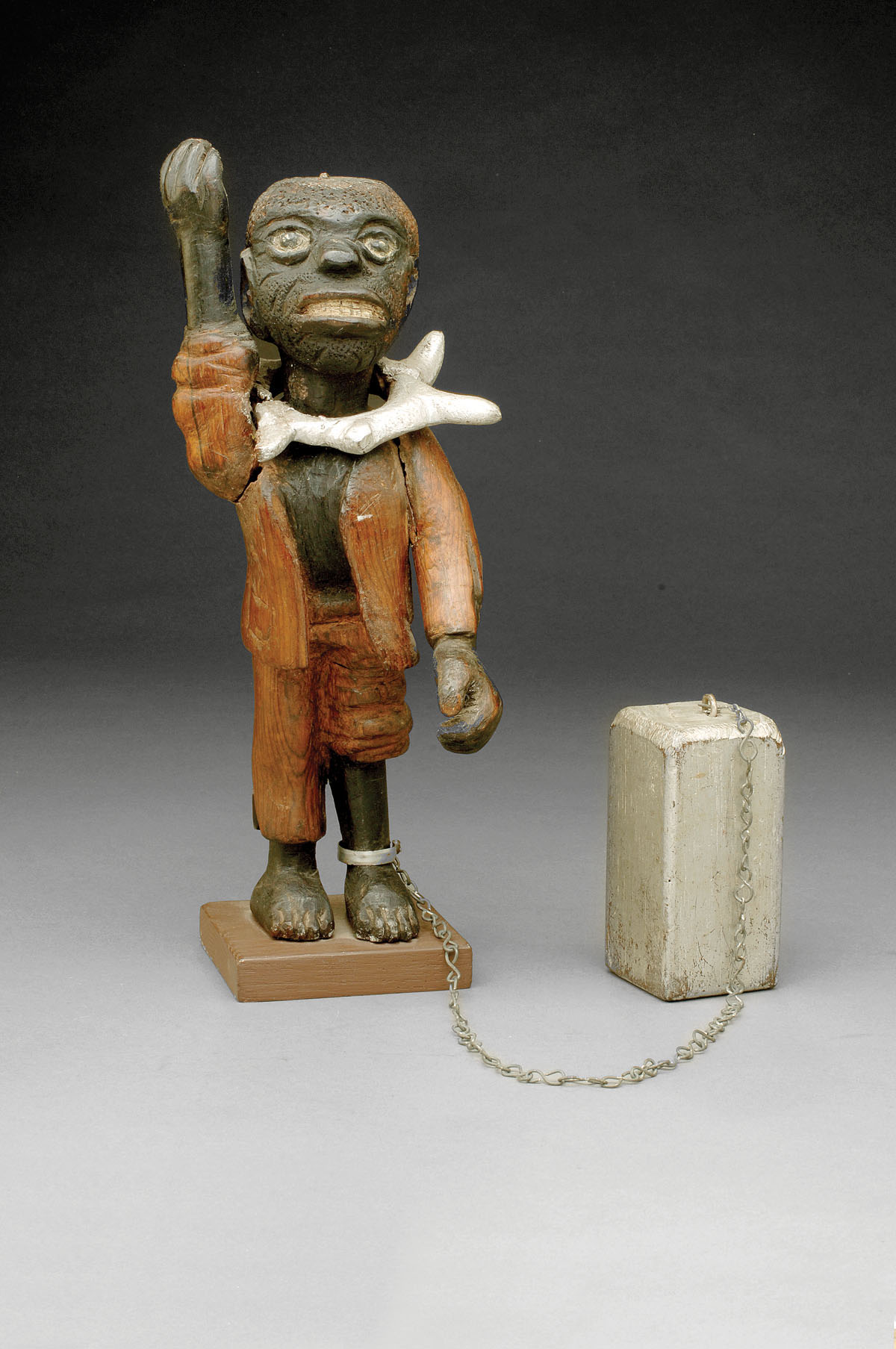 Appraisal: FOLK ART CARVED FIGURE OF A CHAINED SLAVE Depicting a