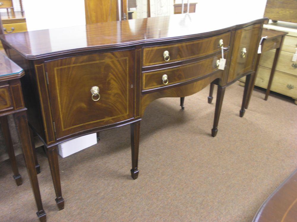 Appraisal: A George III style mahogany sideboard serpentine fronted with two