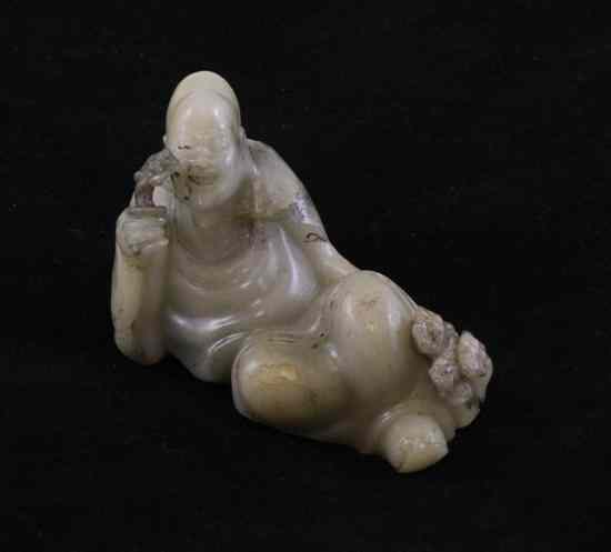 Appraisal: A Chinese cream coloured soapstone figure of a reclining Luohan