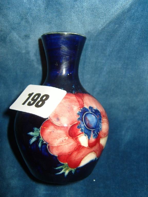 Appraisal: A small dark blue ground Moorcroft vase with drawn neck