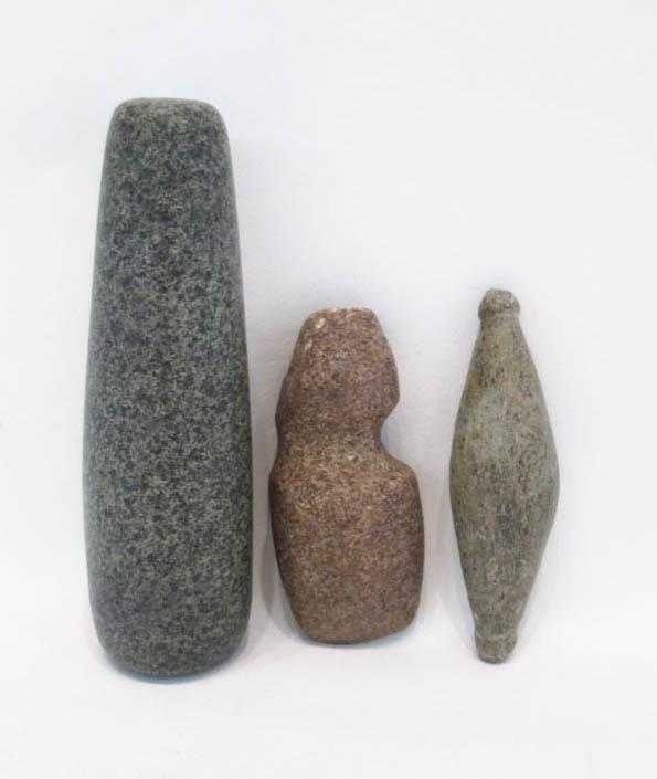 Appraisal: THREE STONE ARTIFACTS pestle in green granite grooved ax and