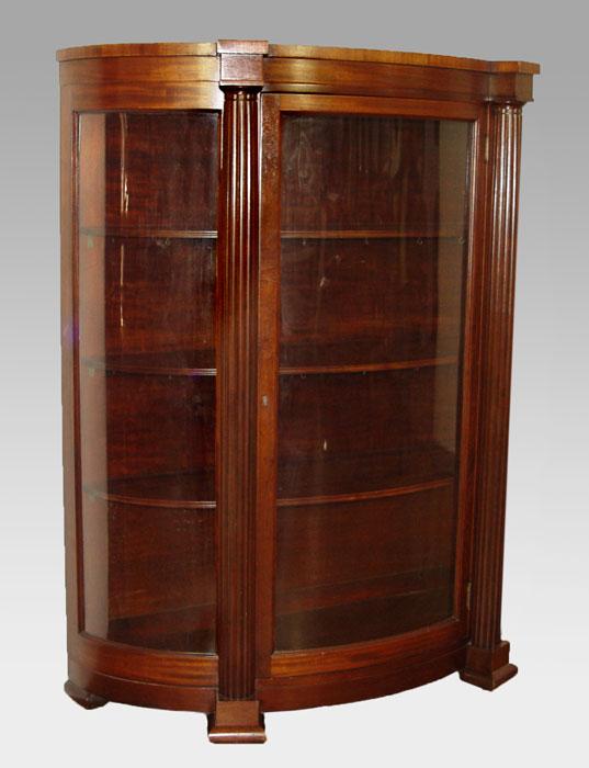 Appraisal: MAHOGANY TRIPLE BOW FRONT CHINA CABINET Full length fluted columns