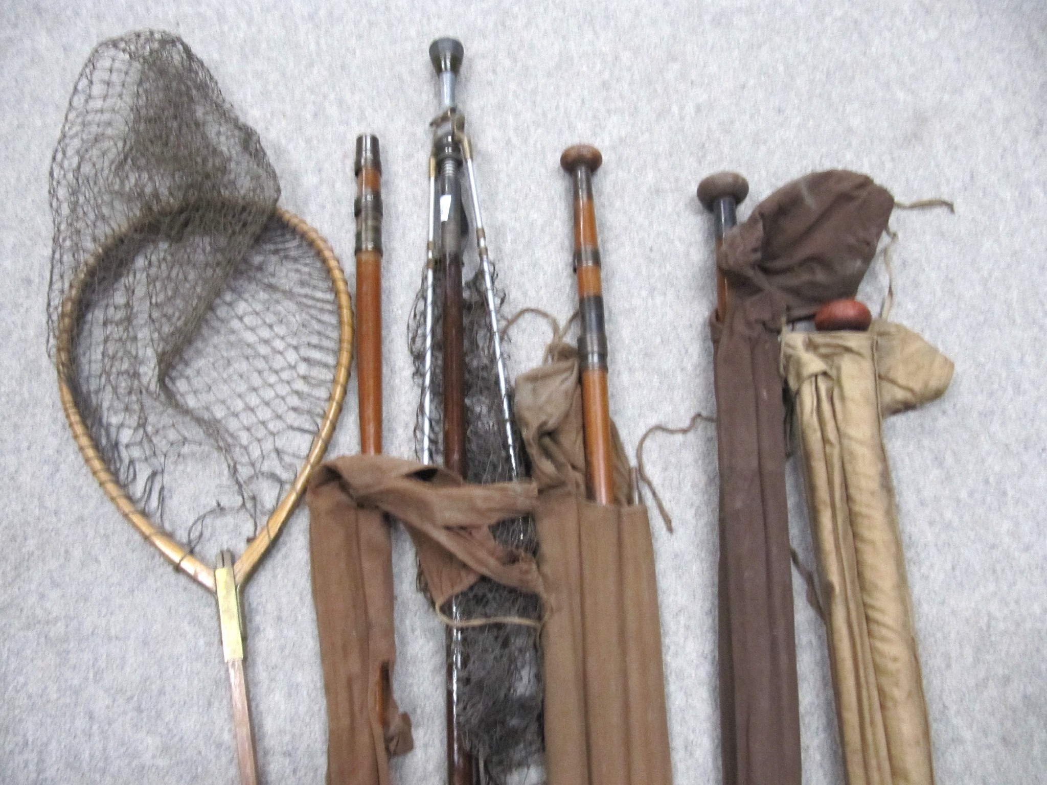 Appraisal: A lot comprising four fishing rods and two nets