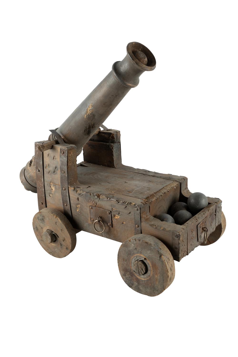 Appraisal: CARVED WOOD CANNON MODELaccompanied with four wood cannon balls metal