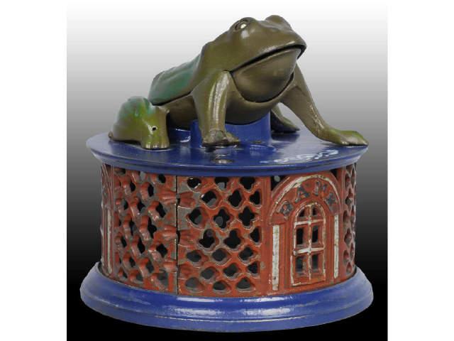 Appraisal: Cast Iron Frog on Lattice Mechanical Bank Description Manufactured by