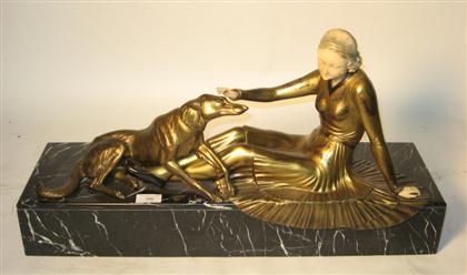 Appraisal: An Art Deco style bronzed and ivorine figureOf a recumbent