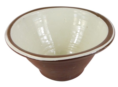 Appraisal: A terracotta and slipware cream bowl cm wide