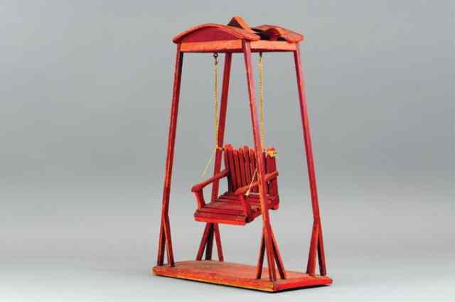 Appraisal: CHILD'S DOLL SWING Wooden support and slot back swinging chair