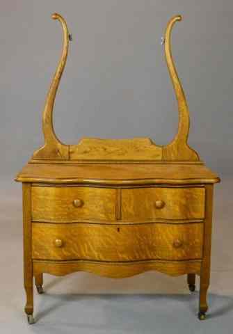 Appraisal: Victorian Tiger Oak Three-Drawer Dresser WashstandSerpentine overhang top above two