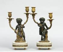 Appraisal: Pair of Bronze Figurative Candelabra Both are Bacchanal children one