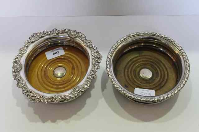 Appraisal: TWO TH CENTURY SILVER PLATED WINE COASTERS with turned bases